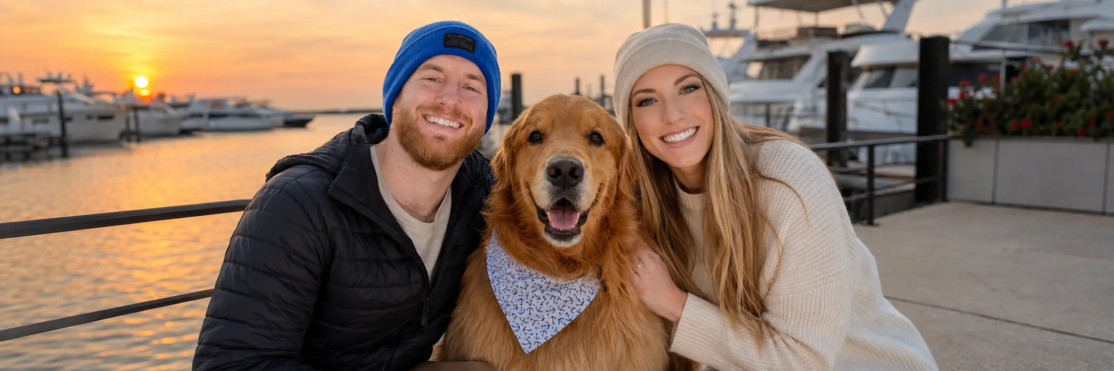 Wally with his owners at the marina at sunset